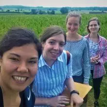 Members of the lab in a field inspecting the crop for any signs of disease